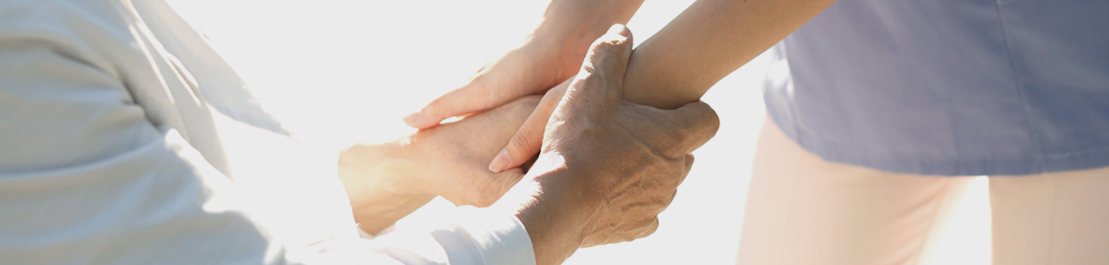 The image of the old man and the nurse holding hands